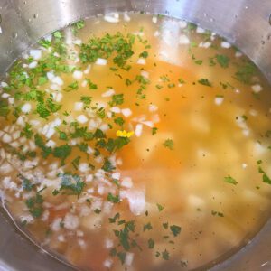 Chicken broth added to pot