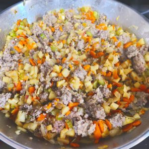 Sausage fully cooked with veggies and apples