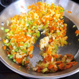 Pan on stove with sautéed veggies