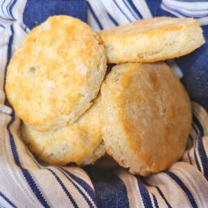 gluten free flakey biscuits in a bowl with a blue and gray striped towel