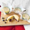 Lemon Blueberry Mini-Cakes on a wooden cutting board with a red cloth napkin underneath