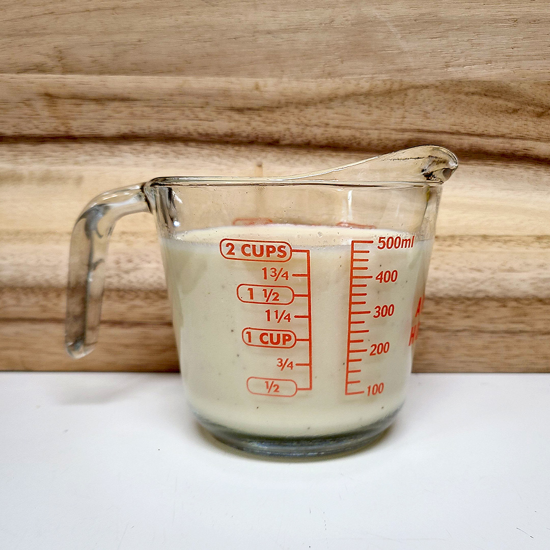 Cream of Chicken soup in glass measuring cup