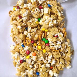 Popcorn Party Mix cooling on parchment paper