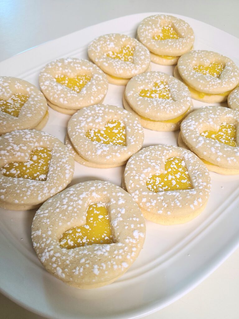 Gluten Free Lemon Bar Sugar Cookies with a heart cut out and powdered sugar sprinkled on top