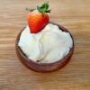 Whipped Cream & Lemon Curd Fruit dip in a small wooden bowl