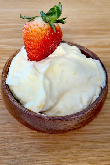 Whipped Cream & Lemon Curd Fruit dip in a small wooden bowl