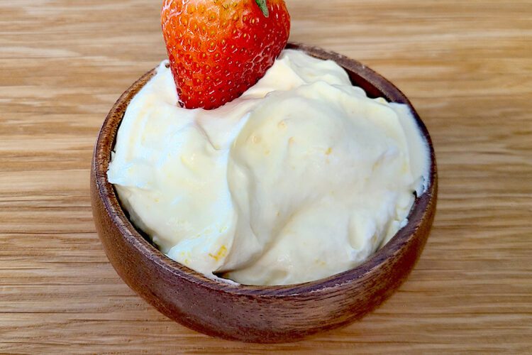 Whipped Cream & Lemon Curd Fruit dip in a small wooden bowl