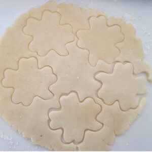 shamrock shaped cookies cut out of dough