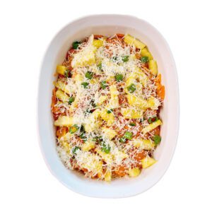 layers of sweet potatoes, pineapple, green onions, and cheese in a white casserole dish