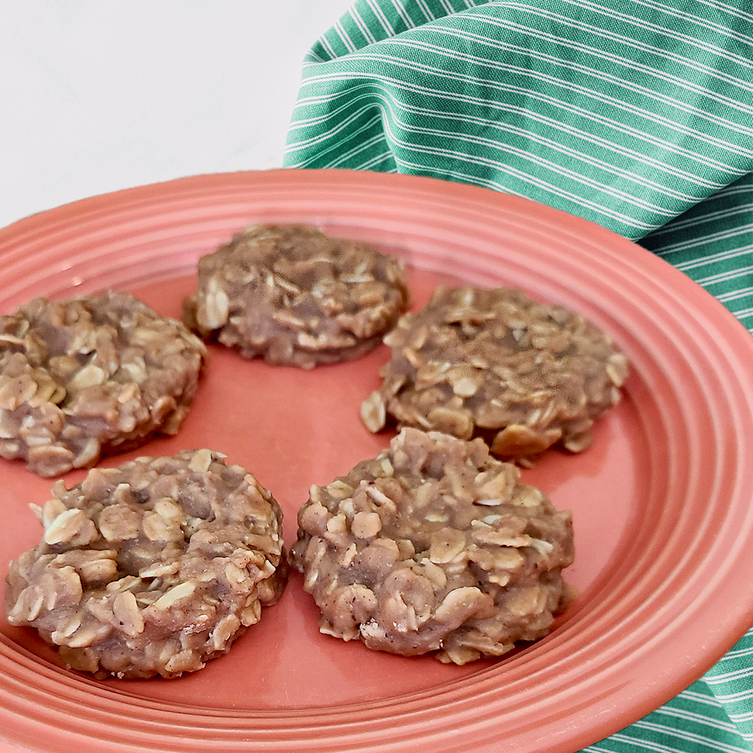 no bake cookies on a salmon colored plate with a teal striped cloth behind