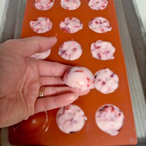 strawberry yogurt bites frozen, one shown in hand