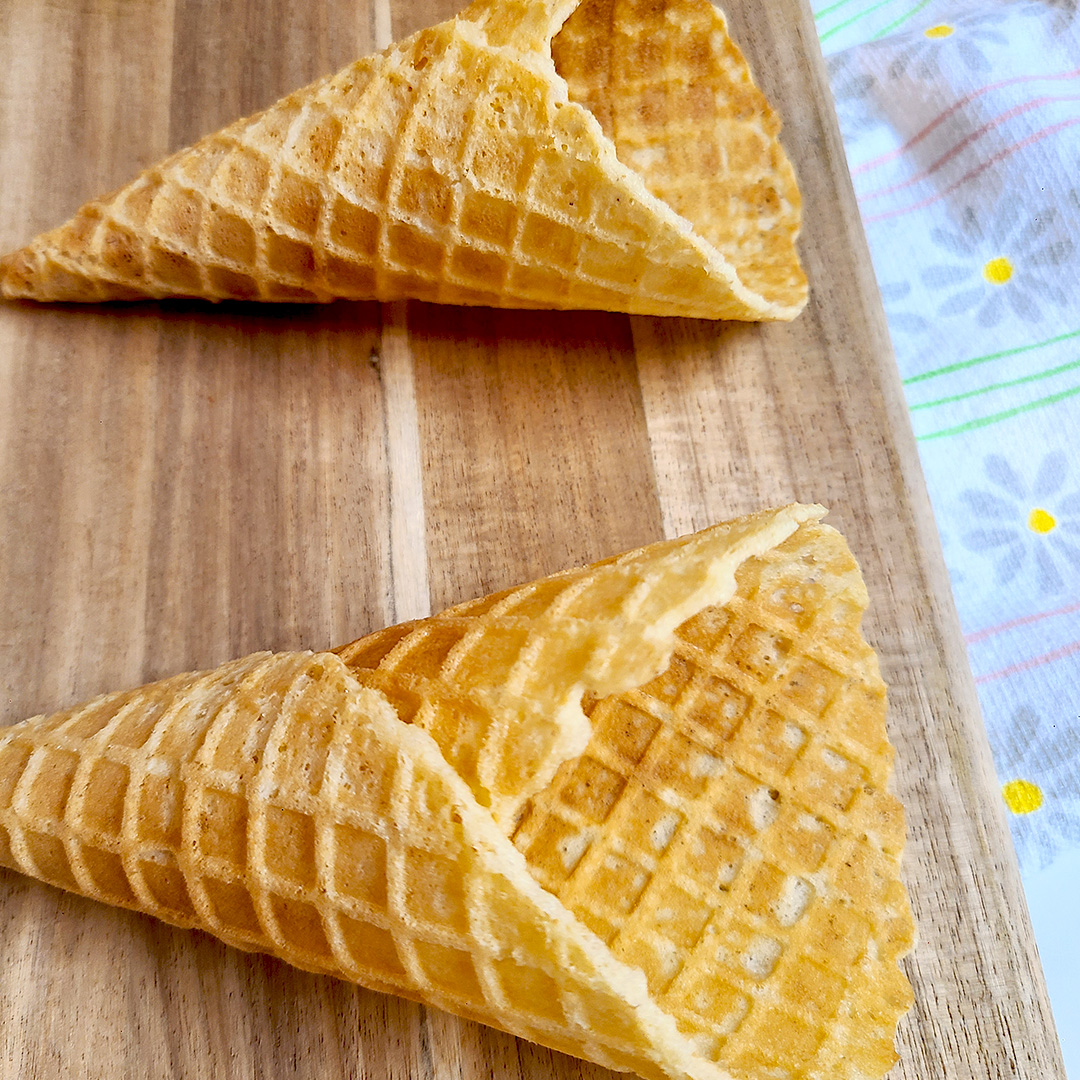 gluten free waffle cone on wooden board with flower towel underneath