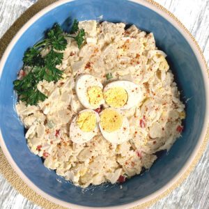 potato salad in a large light blue bowl