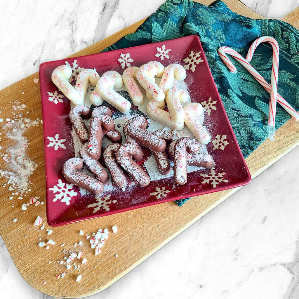 milk and dark chocolate shaped candy canes sprinkled with crushed peppermint candy canes