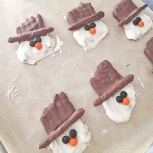 gluten free pretzel snowman on baking sheet