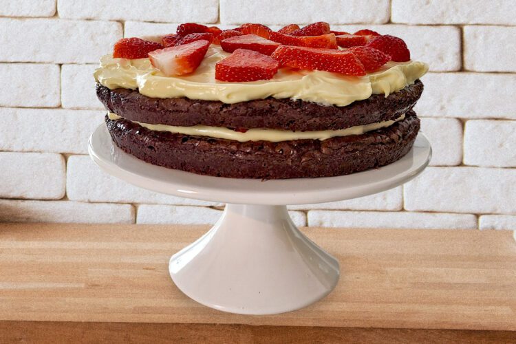 Gluten Free Strawberry Brownie Torte on a white cake stand