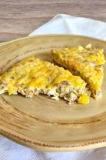 Egg Sausage & Veggie skillet sliced in triangles on a brown plate