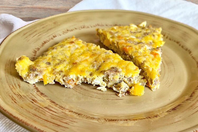 Egg Sausage & Veggie skillet sliced in triangles on a brown plate