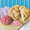 Braided Gluten Free Bread on a wooden cutting board with cranberry honey butter