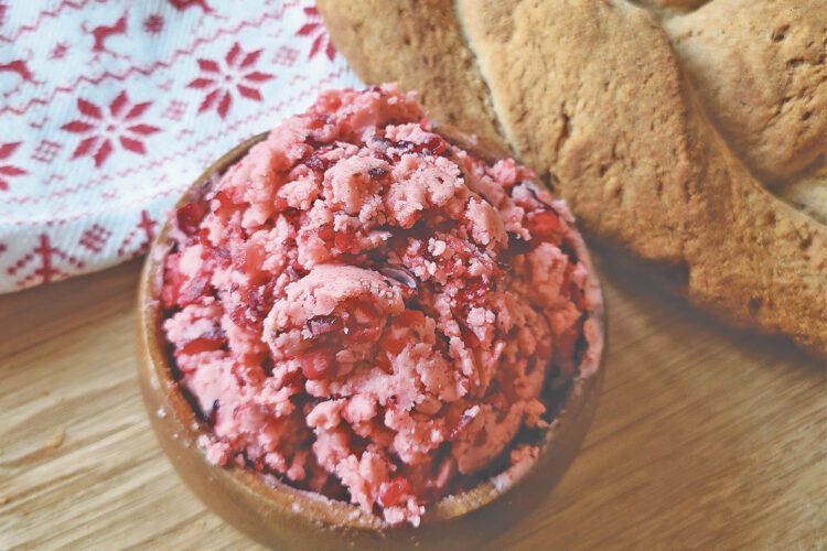 Cranberry Honey Butter in a small wooden bowl next to a loaf of gluten free bread