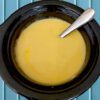 Homemade gluten free cheese dip in a small black crockpot