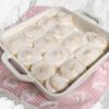 Gluten free cinnamon rolls baked in a white square dish