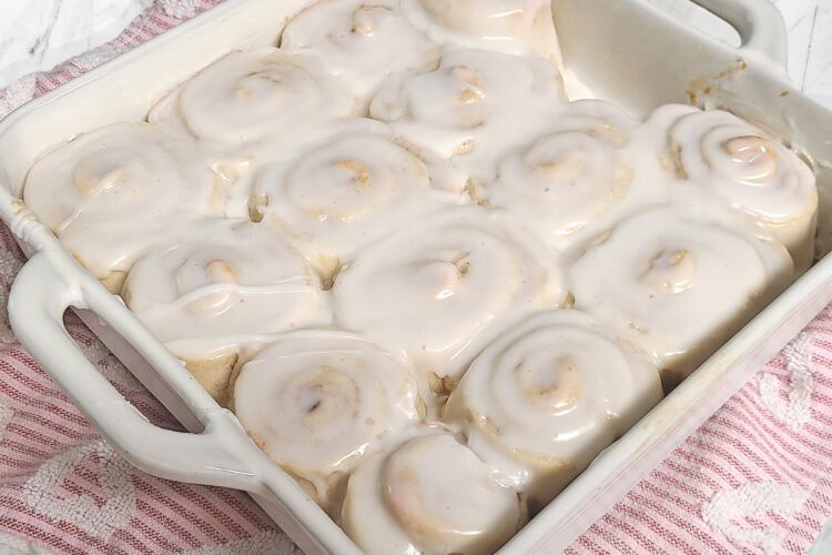 Gluten free cinnamon rolls baked in a white square dish